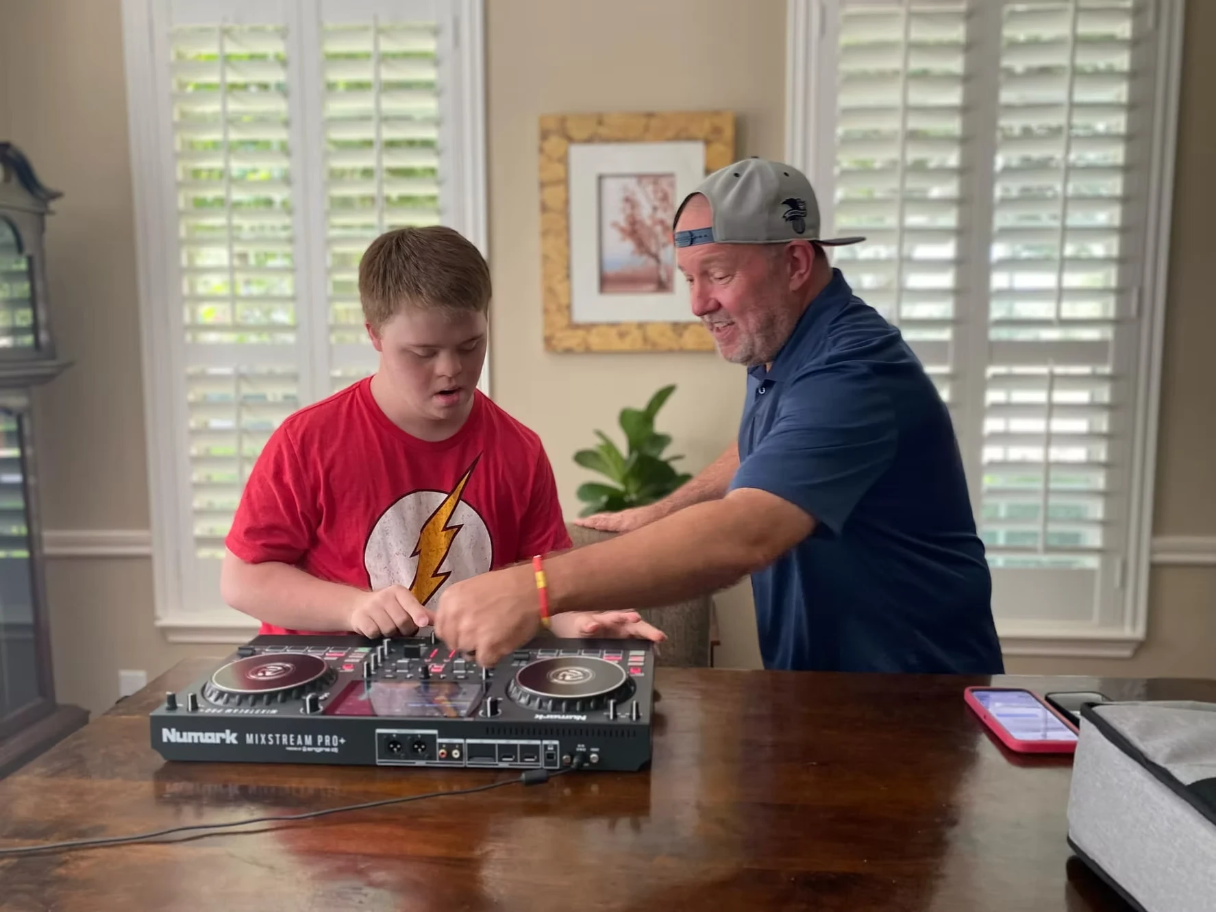 DJ Dash showing his friend how to be a disc jockey